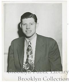 [Lou Ruchser in suit and tie]