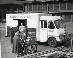 [Workers buying lunch from a food truck ]