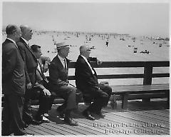 [Five men on boardwalk]