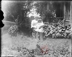 [Woman and little girl in garden]