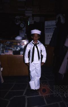 [Inside Reliable and Frank's, young customer in a Navy uniform]