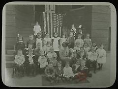[Group portrait of woman with kindergarten class]