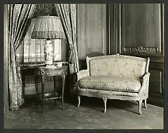 Weil-Worgelt apartment; settee and end table with lamp in French eighteenth-century revival style.